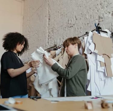 Ethical garment manufacturing workers assembling apparel in clean production space
