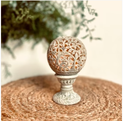 a decorative ball with a decorative ball on a table