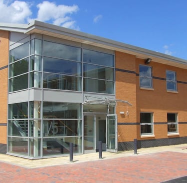 commercial building with beautiful glass entrance atrium, customer of C Thru Window Cleaning, Exeter.