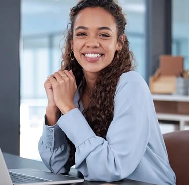 a woman sitting at a desk with a laptop