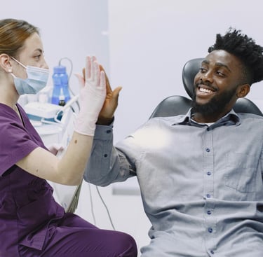smiling happy patient by the dentist