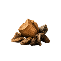 A pile of aromatic agarwood and oud wood chips isolated on a black background.