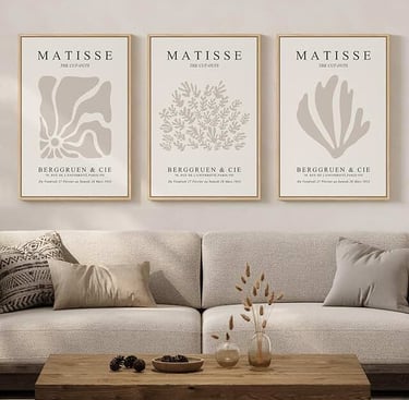 Three framed Matisse cut-out art prints hanging above a neutral beige sofa in a modern living room.
