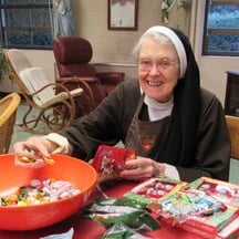 A Carmelite nun stuffing candies.