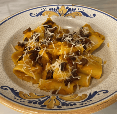 Rigatoni pasta with creamy butternut squash sauce, crispy pancetta, and grated parmesan cheese.