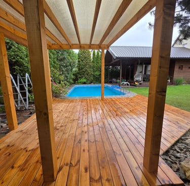 a wooden deck with a pool and a wooden deck