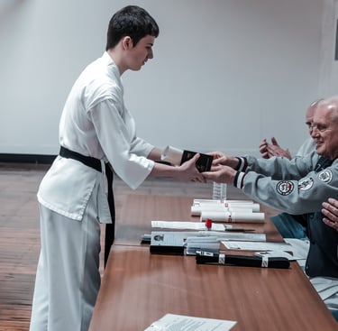 Sensei Dave Kershaw awards student with shodan grade