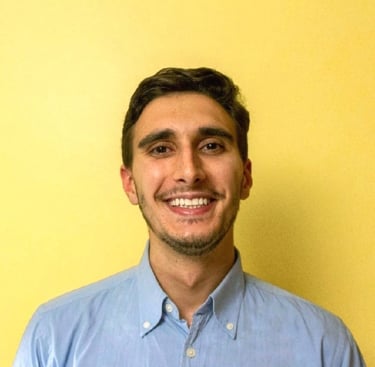 a man in a blue shirt and tie dye on a yellow background
