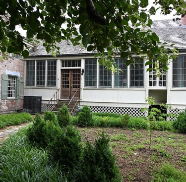 View of back of historic Jacques Guibourd Historic House in garden in Ste Genevieve, Missouri