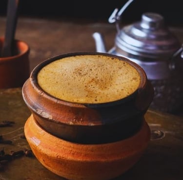 a cup of coffee with a teapot and a teapot
