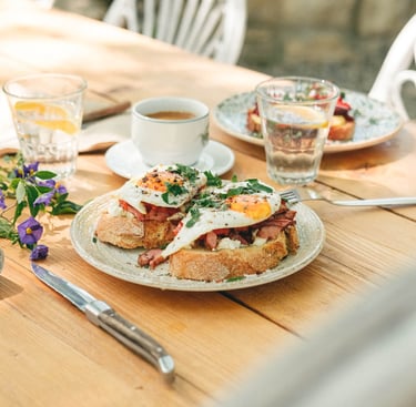 a table with a plate of greek mezze and a cup of coffee