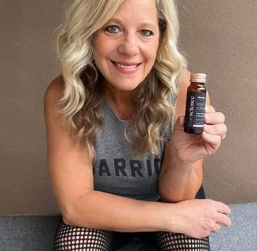 Jody holding a bottle of Liquid Collagen