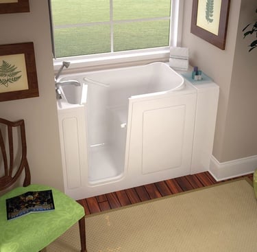 Compact white walk-in bathtub with easy-access door, built-in seat, and chrome faucet, installed by New Bath Elite in a brigh