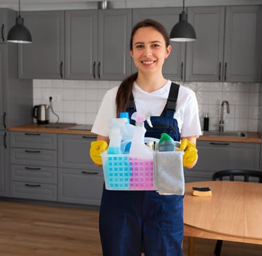 KLEAN WELL technician holding a caddy of eco-friendly cleaning supplies in a modern kitchen—Speciali