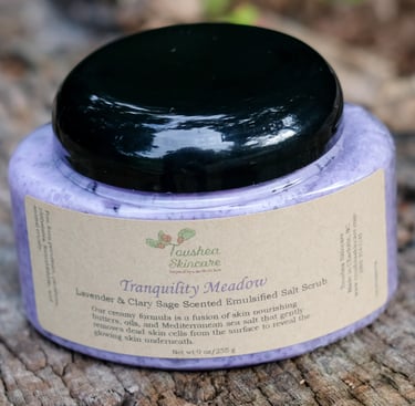 jar of lavender colored sea salt scrub on a tree stump