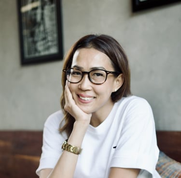 a woman in glasses and a white shirt