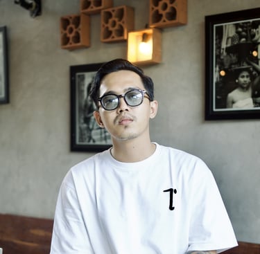 a man with glasses and a white shirt