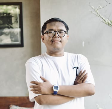 a man with glasses and a watch on his arm