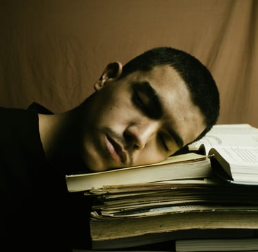 jeune homme fatigué, la tête sur ses livres
