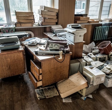 messy office with piles of old junk