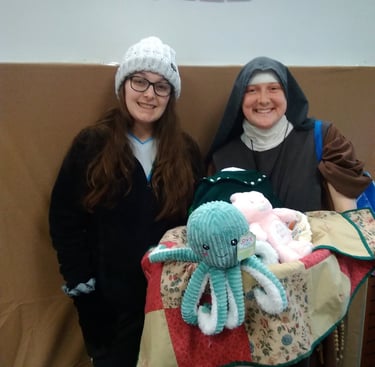 A mom receives a new baby welcome basket at the Rose Garden Mission