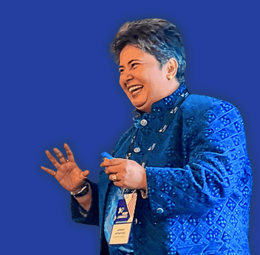 a woman in a blue jacket sharing a joke with audience during keynote