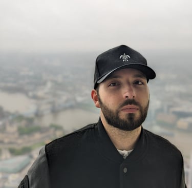 a man in a black jacket wearing a classic tortuga island black cap