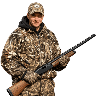 Guided hunting expert in camo gear holding a shotgun for Texas panhandle waterfowl and upland hunts
