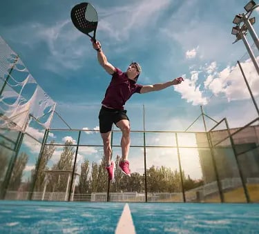 a man is jumping in the air with a tennis racket