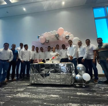 a group of men standing around a table with balloons