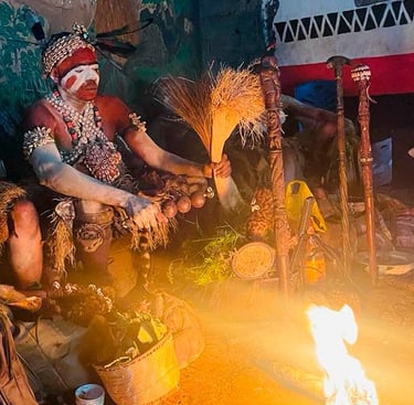 a group of people sitting around a fire. Bwiti ceremony