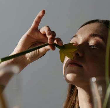 a woman is holding a flower in her hand