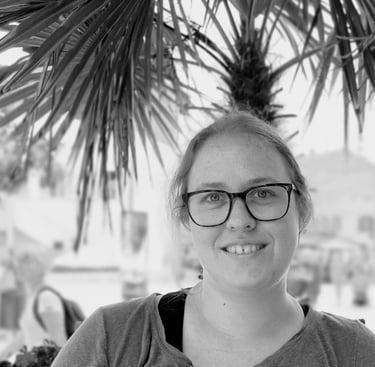 a woman in glasses and a gray shirt