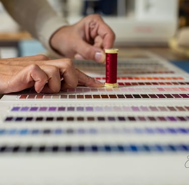 a person is holding a needle and thread thread
