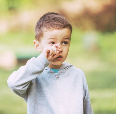 Child rubbing his eye