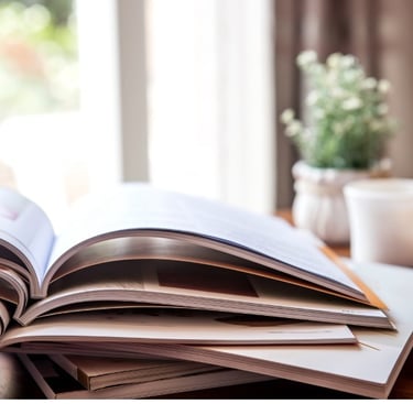 Books on a table with coffee mug and plant