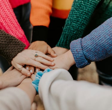 a group of people holding hands together for collaboration from ededge
