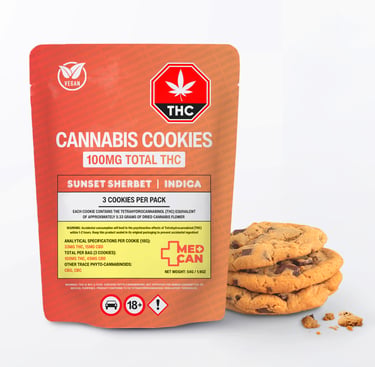 A package of Sunset Sherbet Indica cannabis cookies containing 100mg THC next to a stack of chocolate chip cookies.