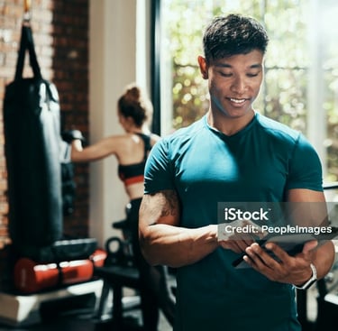 a man in a gym with a tablet and a woman in a gym