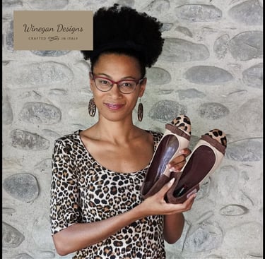 Winegan Designs Crafted in Italy text and picture of Ryan Winegan holding Abstrak Beauty shoes.