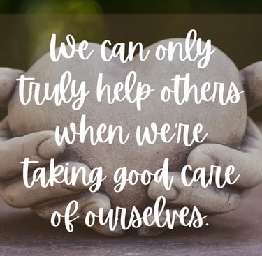 a stone statue of a person holding a heart