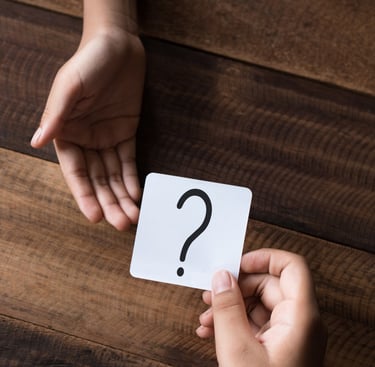 a person holding a card game card game