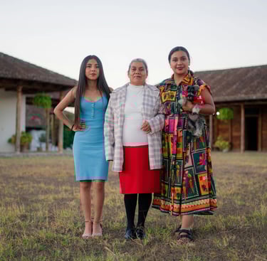 3 women: young, middle aged, elder standing confidently next to each other.