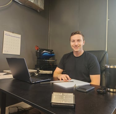 man sitting at office desk smiling
