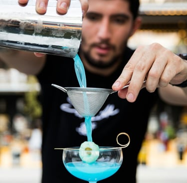 a bar mixer is pouring a cocktail. Staff Training in Hospitality with Timea Pokol Consultant