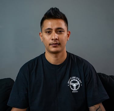 Kiron creating a custom tattoo at Royal Nine Tattoo, showcasing precision linework and tattoo