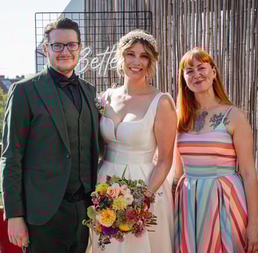 Berlin Hochzeit! das tierliebe Hochzeitspaar glücklich nach der Trauung mit der Rednerin im farbenfrohen Regenbogen-Kleid