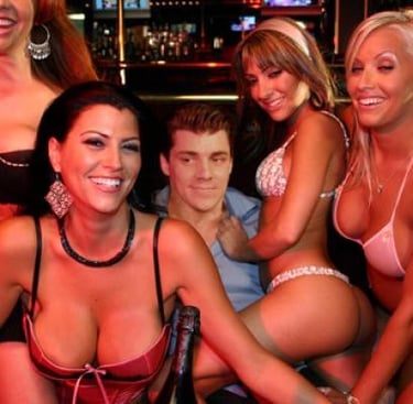 a group of women in bikinis posing for a picture