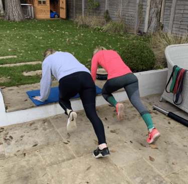Clients working through a personal training workout in Robb Sheridan’s Lightwater home gym.