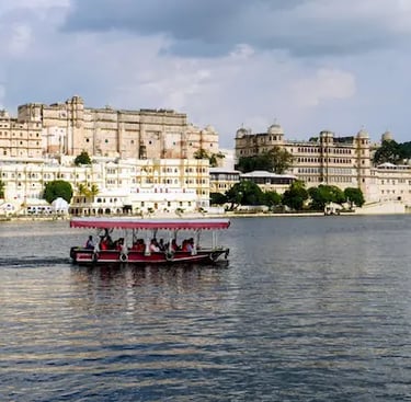 Boat ride on Lake Pichhola with City Palace Udaipur in the background.